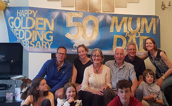 image of my family celebrating mum and dad's 50th golden wedding anniversary with a large hanging banner in the background saying this.